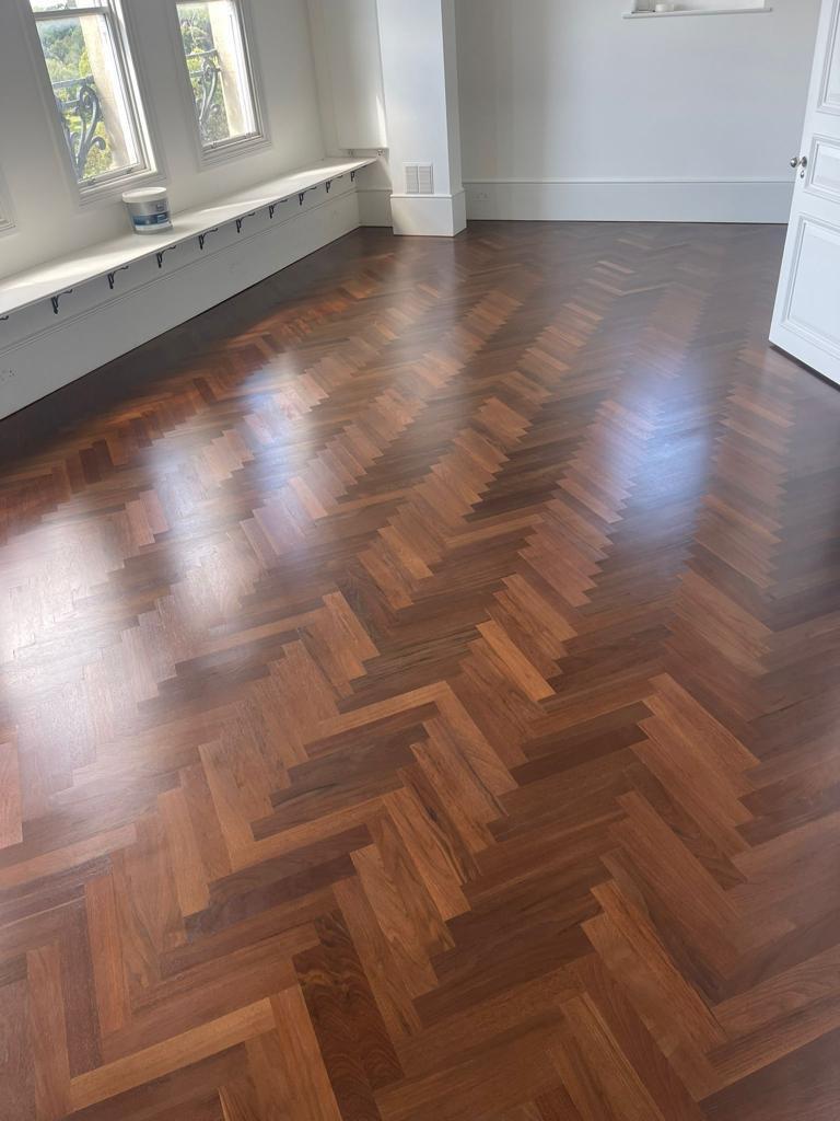 Walnut herringbone — restored to a deep satin finish, by Fix Flooring London